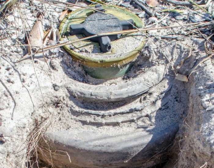 Image of Anti-Personnel mine laid on top of an Anti-Vehicle mine in Angola