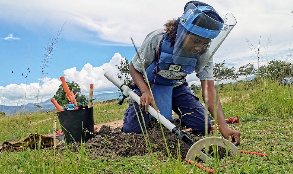 Image of a member of The HALO Trust mine clearance team in Angola working to clear a mine.